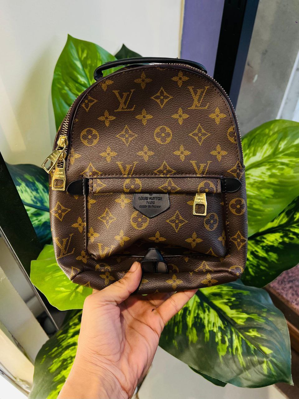 The Louis Vuitton Palm Springs Mini Backpack, crafted in the iconic brown Monogram coated canvas