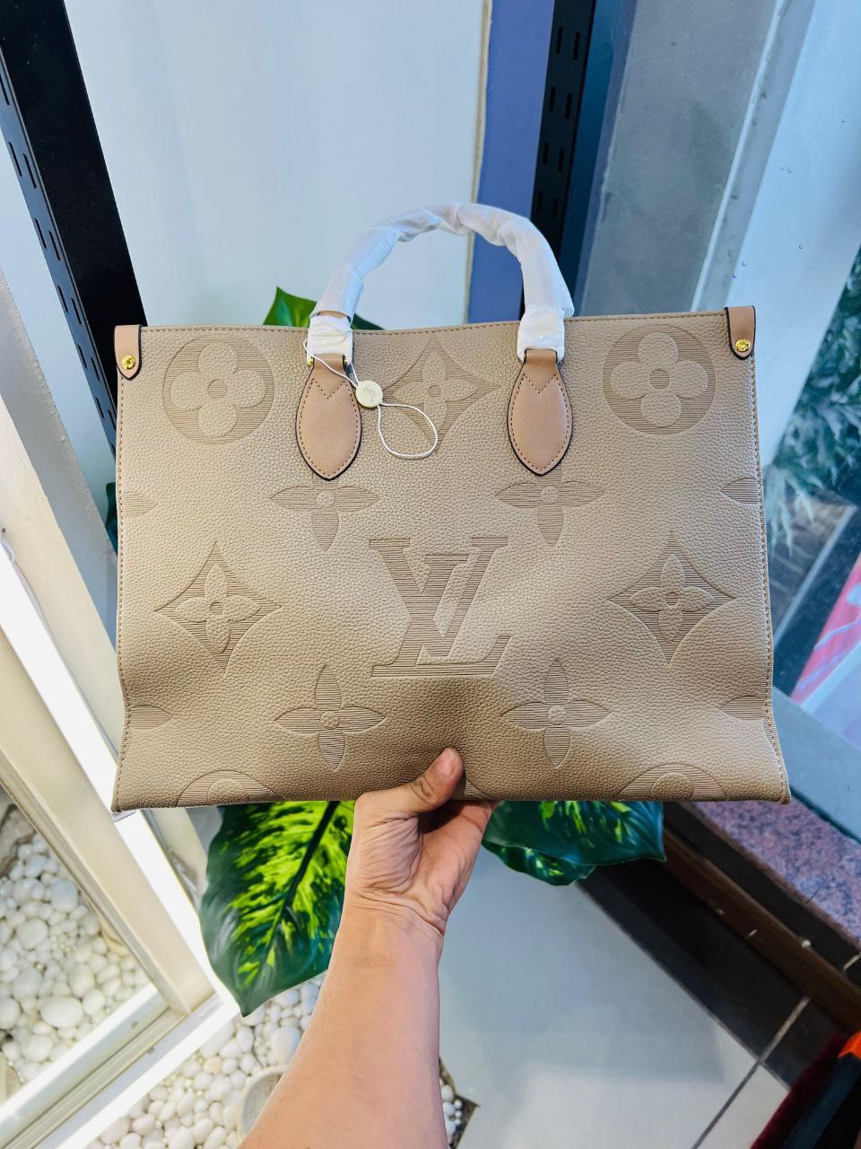 The Louis Vuitton OnTheGo MM tote crafted from supple Monogram Empreinte leather