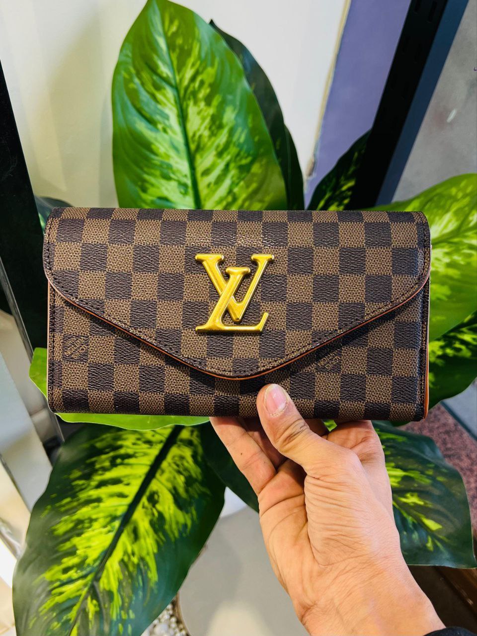 Louis Vuitton Sarah Wallet in Damier Ebene canvas distinguished by its classic brown