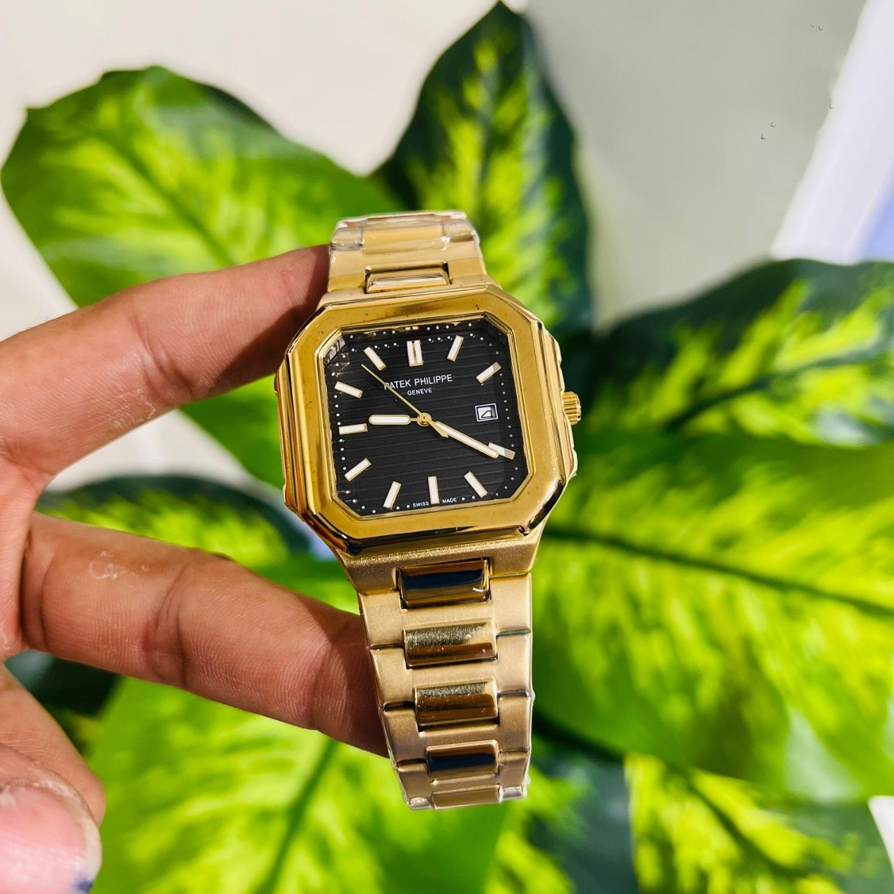 Patek Philippe Cubitus gold watch with a black textured dial