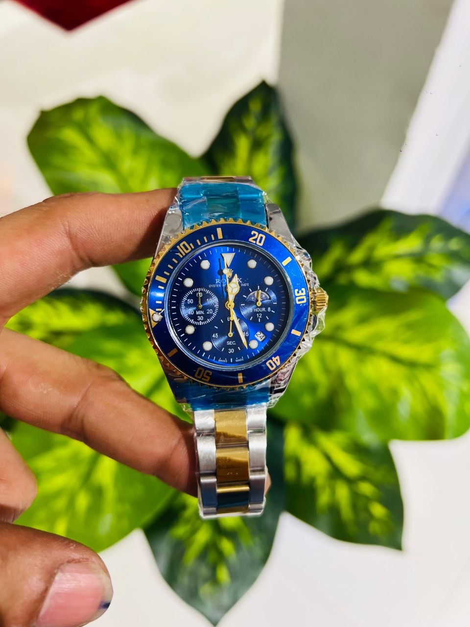 Two tone blue and gold bezel analog watch