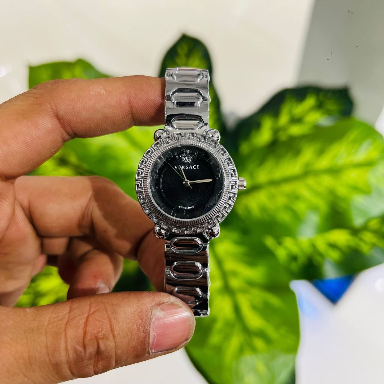 Silver-toned Versace women's wristwatch featuring a black guilloché dial