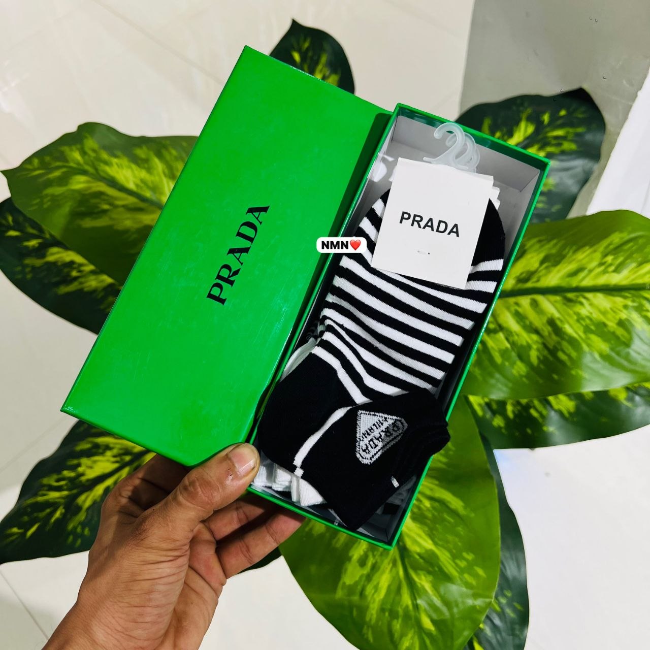 Black and white striped cotton socks featuring the Prada Milano logo